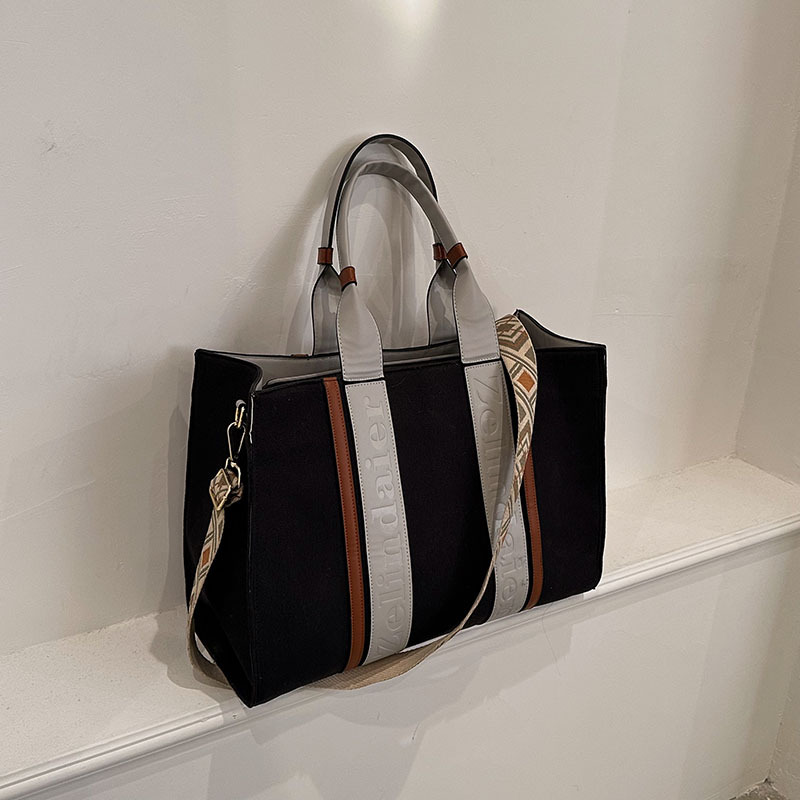 Bolso tote de lona de nuevo estilo con bloques de color, de gran capacidad para mujer, bolso cruzado de moda transfronteriza con sensación de alta gama para el trabajo y el transporte diario.