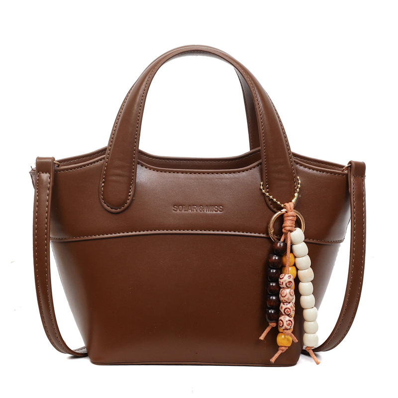 Bolsa de cubo portátil de color contrastante bolso de viaje retro mujer otoño / invierno 2025 nueva moda versátil bolso de hombro