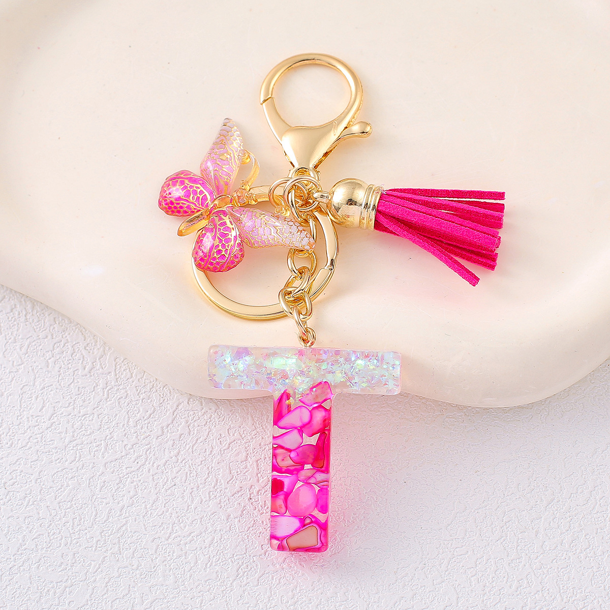2024 explosión llavero joyería de resina letras bolsos colgantes de dama conchas rojas llavero colgantes de mariposa