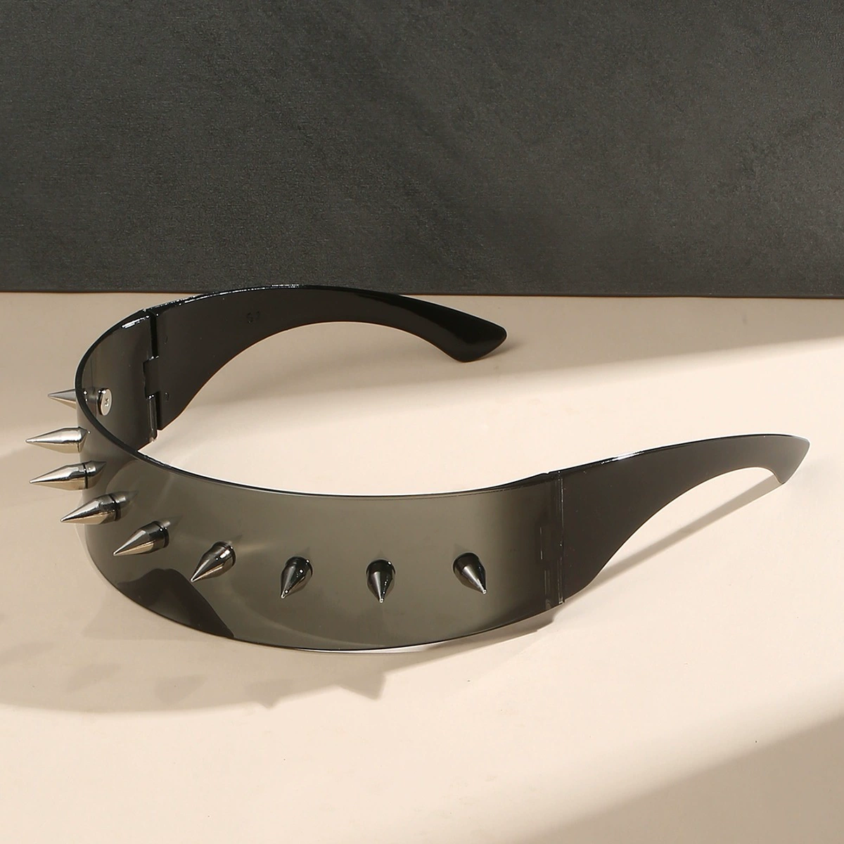 Sunglasses punk style, spike-studded fashion shades, black tinted lens