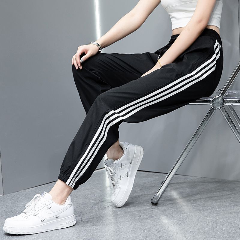 2023 Pantalones deportivos de primavera y otoño pantalones largos casuales para hombres y mujeres Comercio exterior Pareja juvenil suelta slim fit pantalones de chándal atados al tobillo