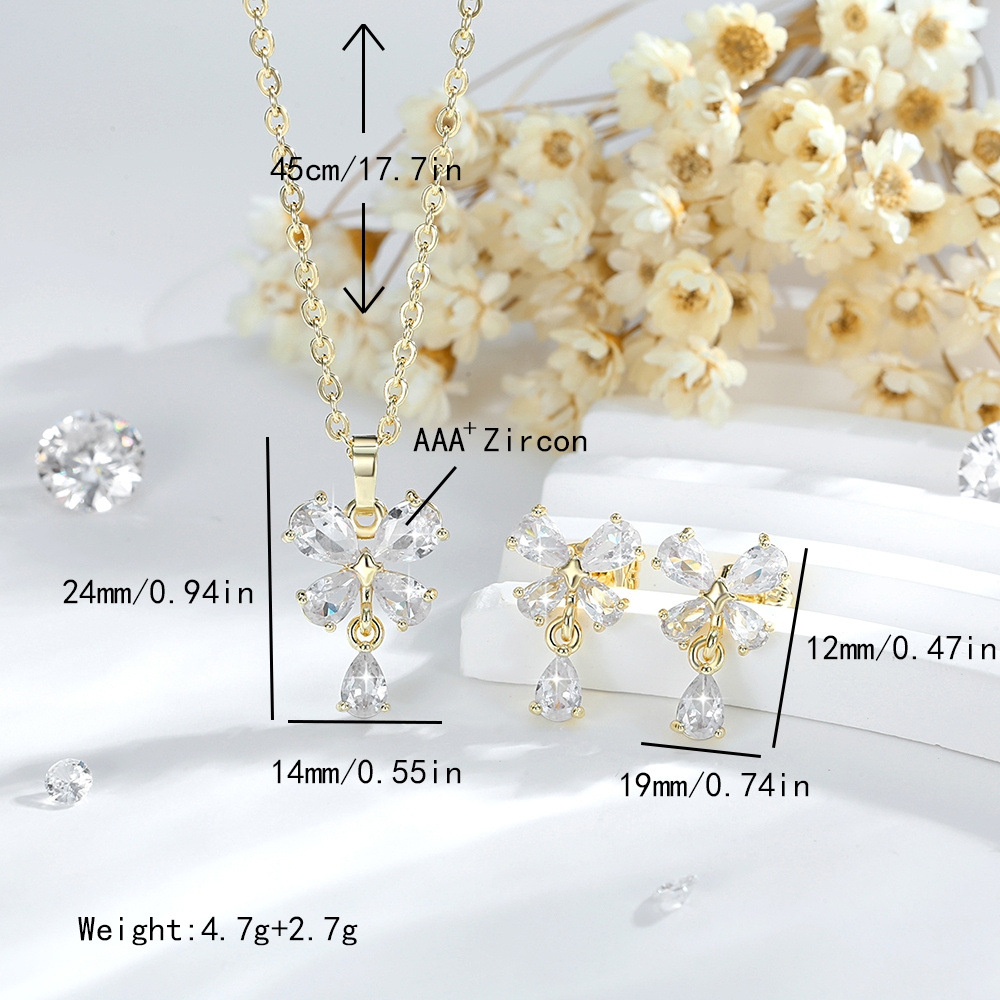 Exquisito conjunto de adornos de flores de cuatro hojas de diseño de moda transfronterizo cobre chapado en oro 14K colgante de flores de zircon aretes