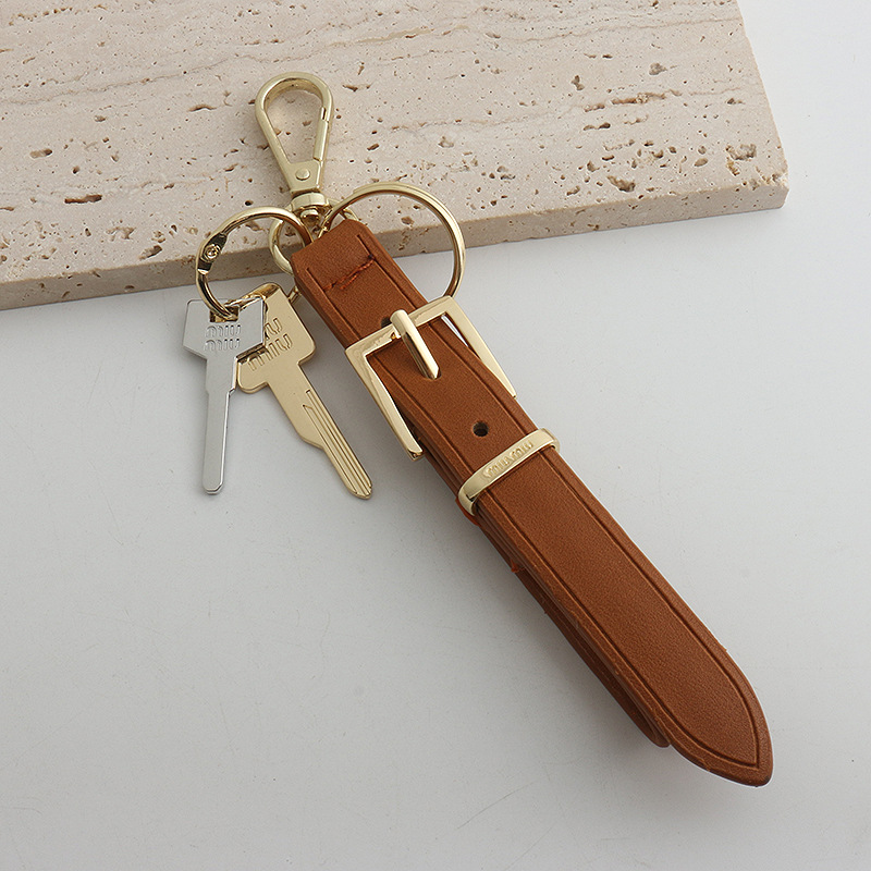 Xiaohongshu ins estilo explosivo uim caja de llaves de cuero colgante llavero de coche colgante pequeño de moda para hombres y mujeres