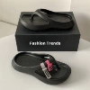 Classic black flip flops, accessory, lifting effect