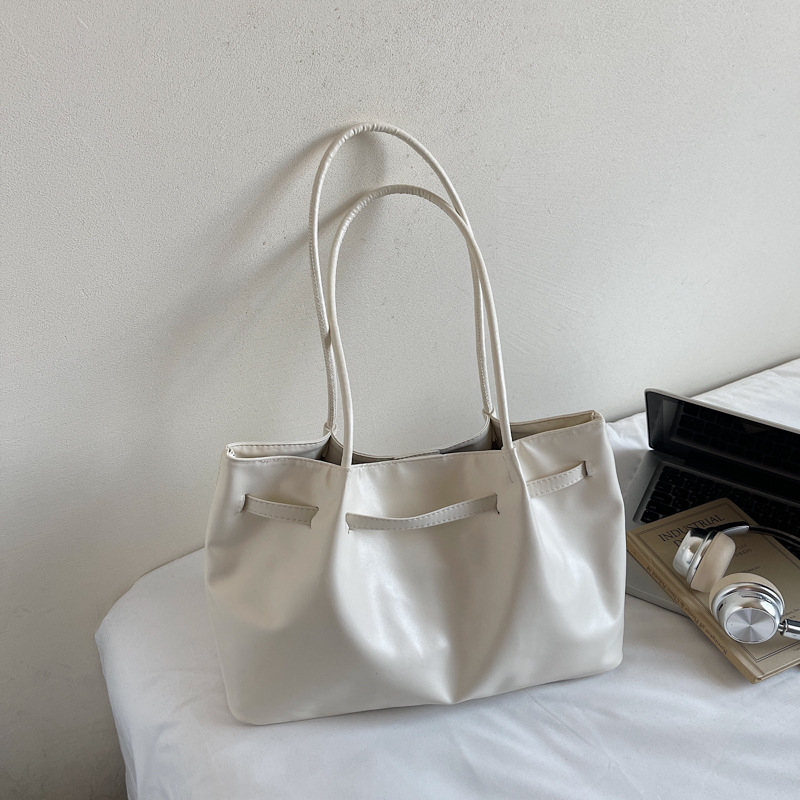 Bolsa de hombro simple y casual 2025, otoño y invierno, nuevo estilo de moda portátil de gran capacidad, bolsa de cubo de transporte de mano