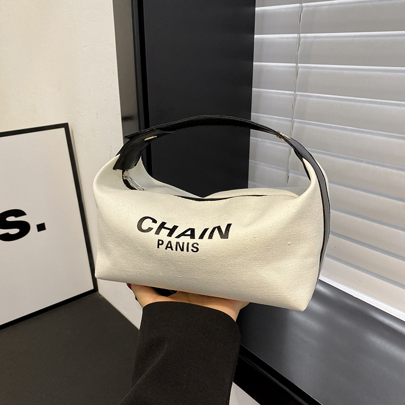 Bolsa de maquillaje de lona simple, nuevo estilo de aire extranjero, bolsa de mano de gran capacidad de almacenamiento, bolsa de almacenamiento simple para viajes