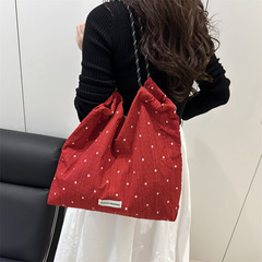 2025夏の新型波点キャンバスバッグシンプルな女性大容量バッグ大学生の授業の小大衆ショルダーバッグ