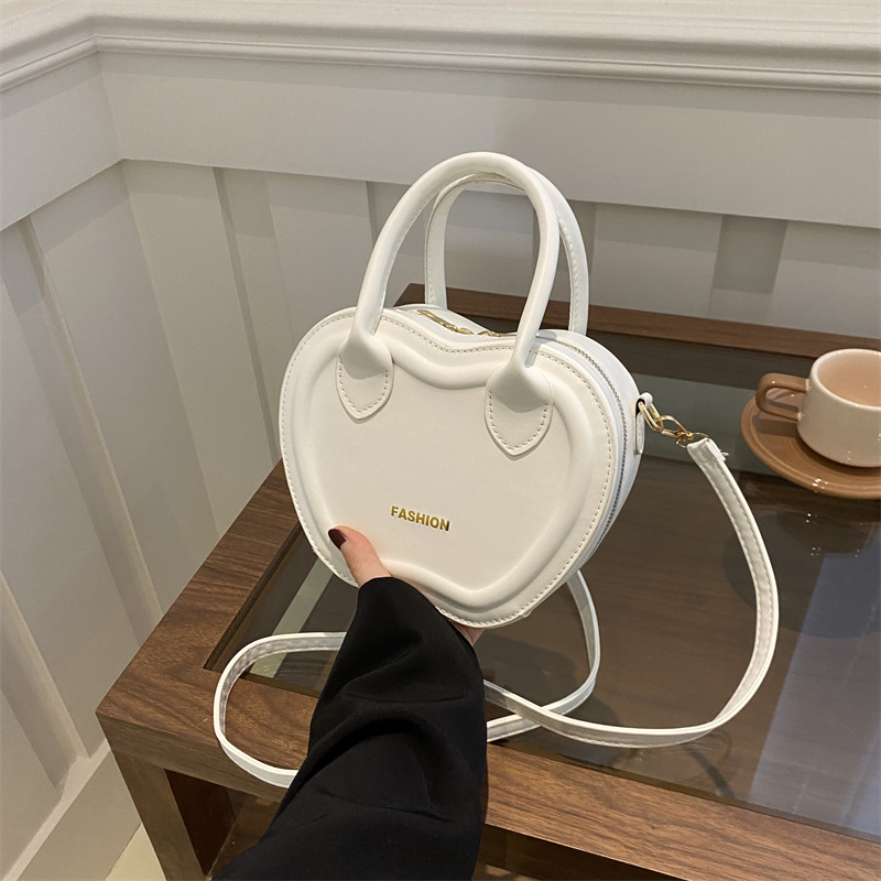 Bolso de mujer 2024 verano nuevo bolso de moda empujada textura PU bolso de hombro simple color sólido mochila de viaje