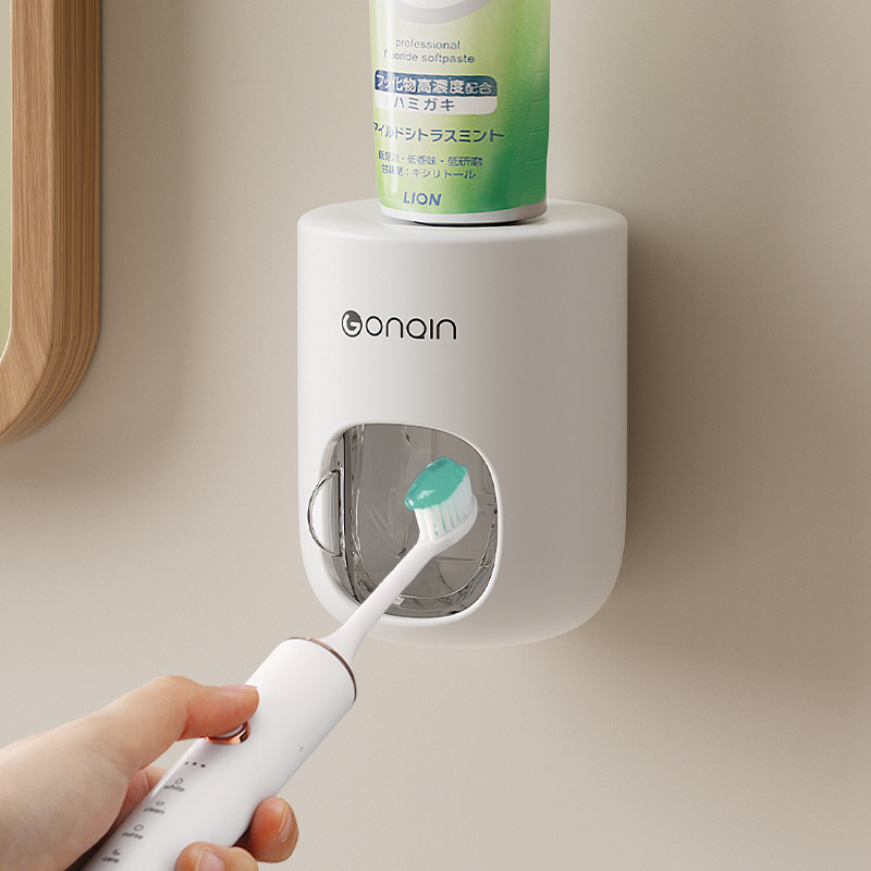 Extrusión automática de pasta de dientes extrusora de pasta de dientes almacenamiento con cubierta a prueba de polvo tipo pared doméstica sin agujeros clip de pasta de dientes al por mayor