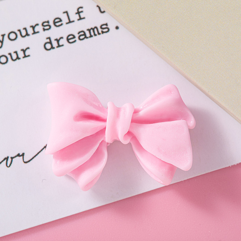 Accesorios de resina de arco de color macaron DIY Crema Accesorios de cuerda de cabello de agujero de caja de teléfono móvil Colgante de hebilla de zapato