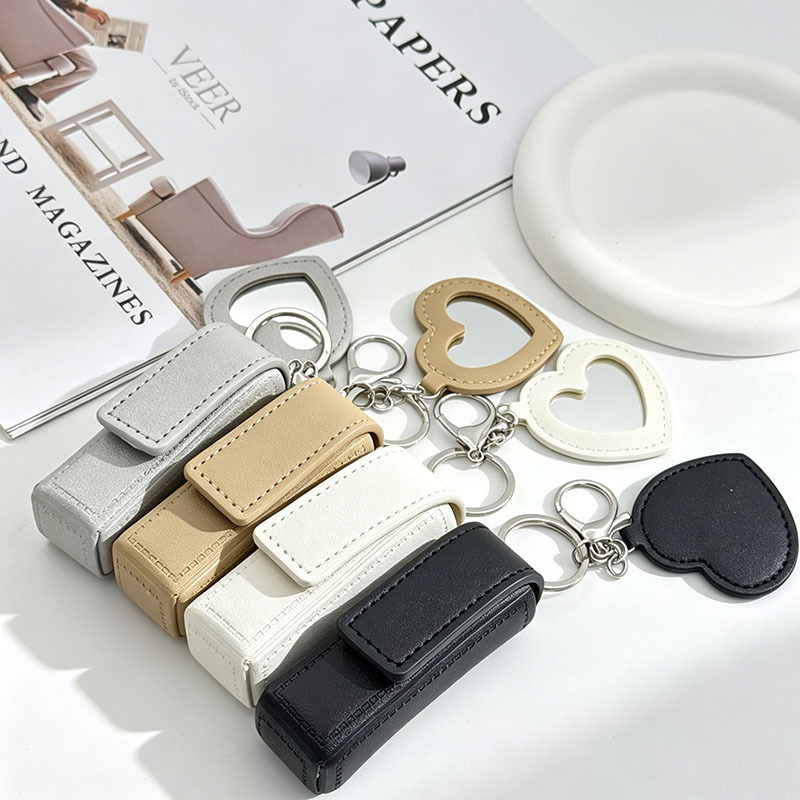 Simple leather lipstick case with magnetic snap closure, mirror, and keychain – a portable makeup bag for women
