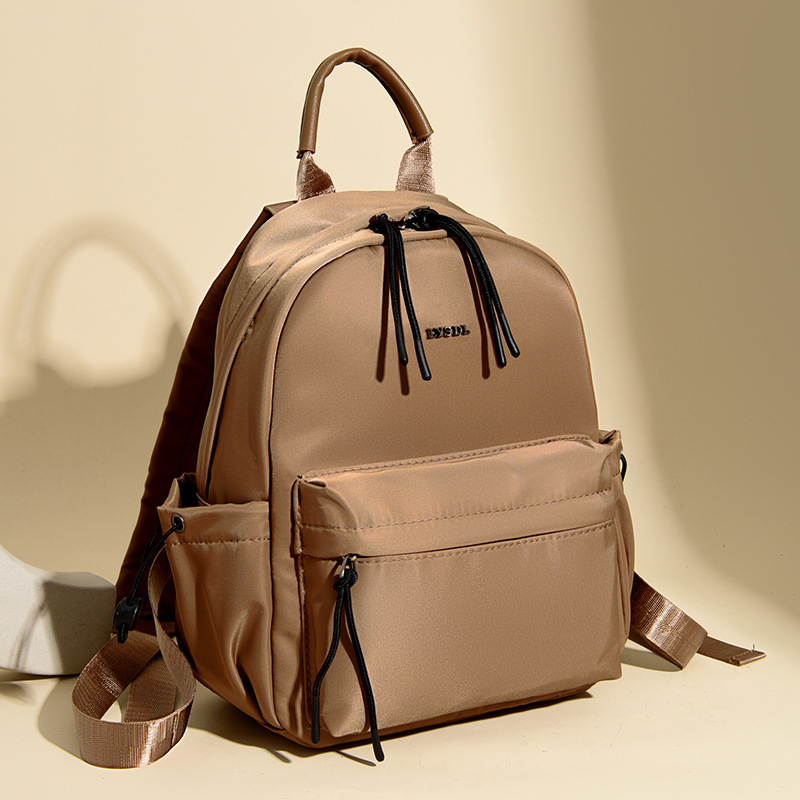 2025 nueva mochila de viaje simple de color sólido mochila de mujer casual letras extranjeras mochila de gran capacidad