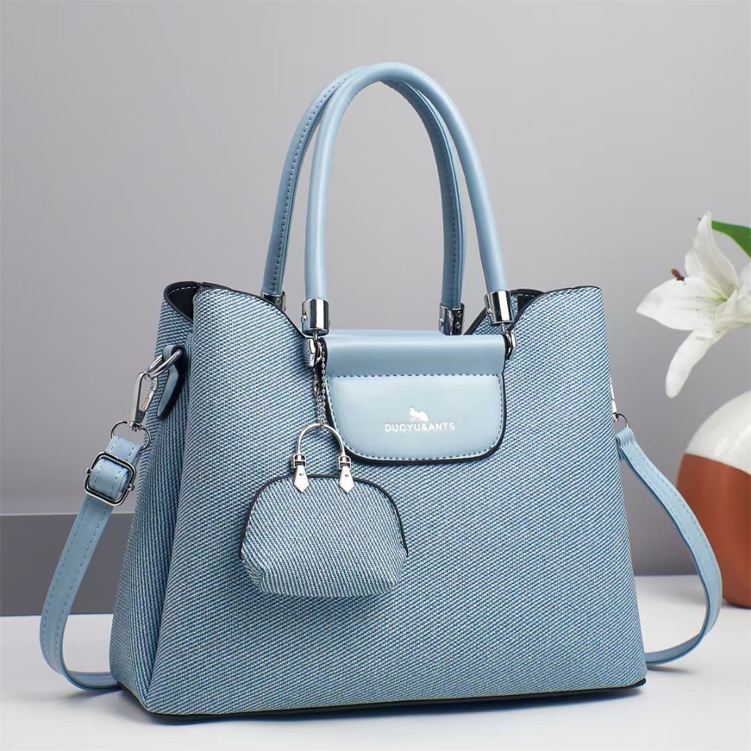 El nuevo bolso de mano para niños y madres está de moda en el bolso de hombro de textura, bolso de mensajero de diseño de nicho coreano de todo fósforo, comercio exterior