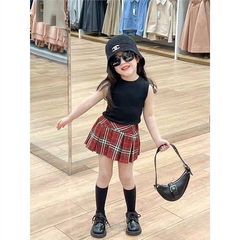 Black vest + plaid skirt