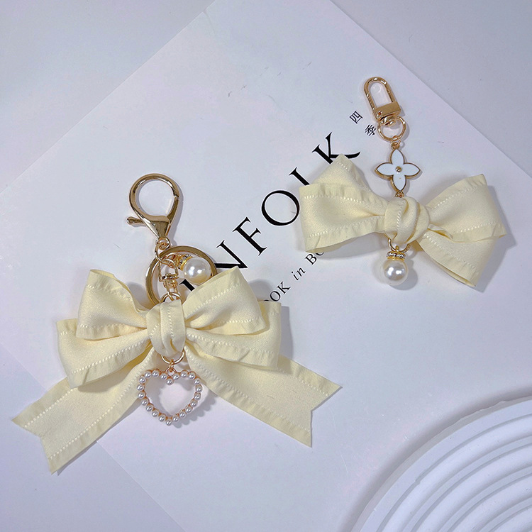 Estilo coreano arrugas cinta arco llavero colgante perla amor chica simple bolsa colgante teléfono móvil colgante